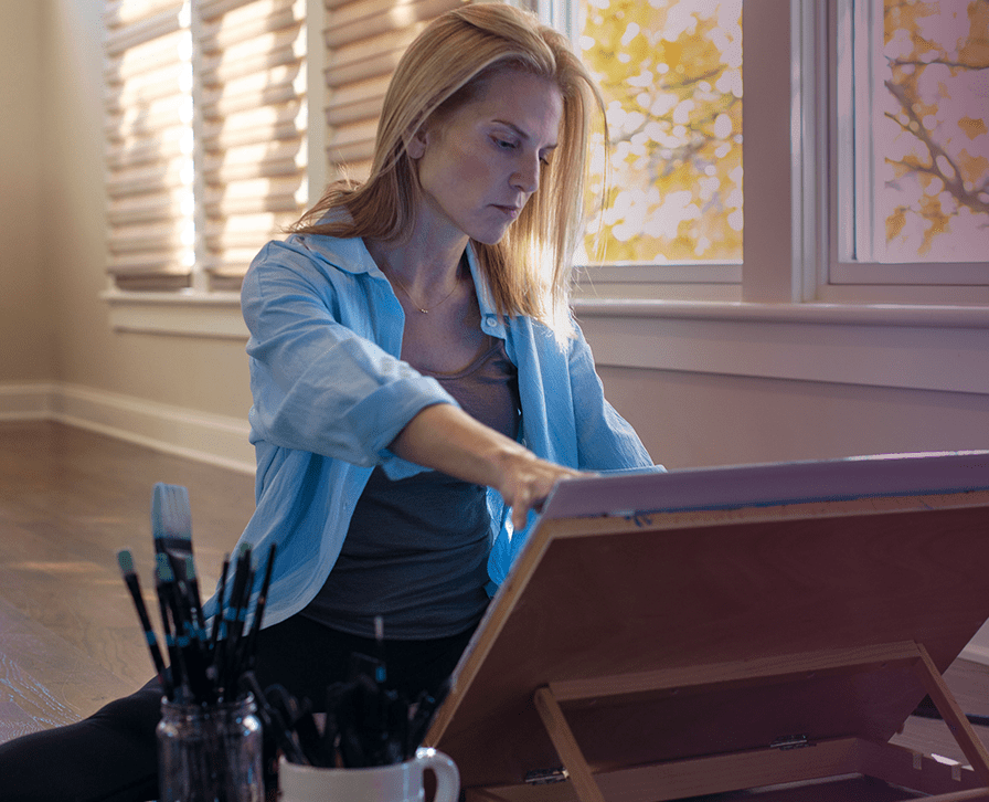 Jeanette Livingston painting in her studio